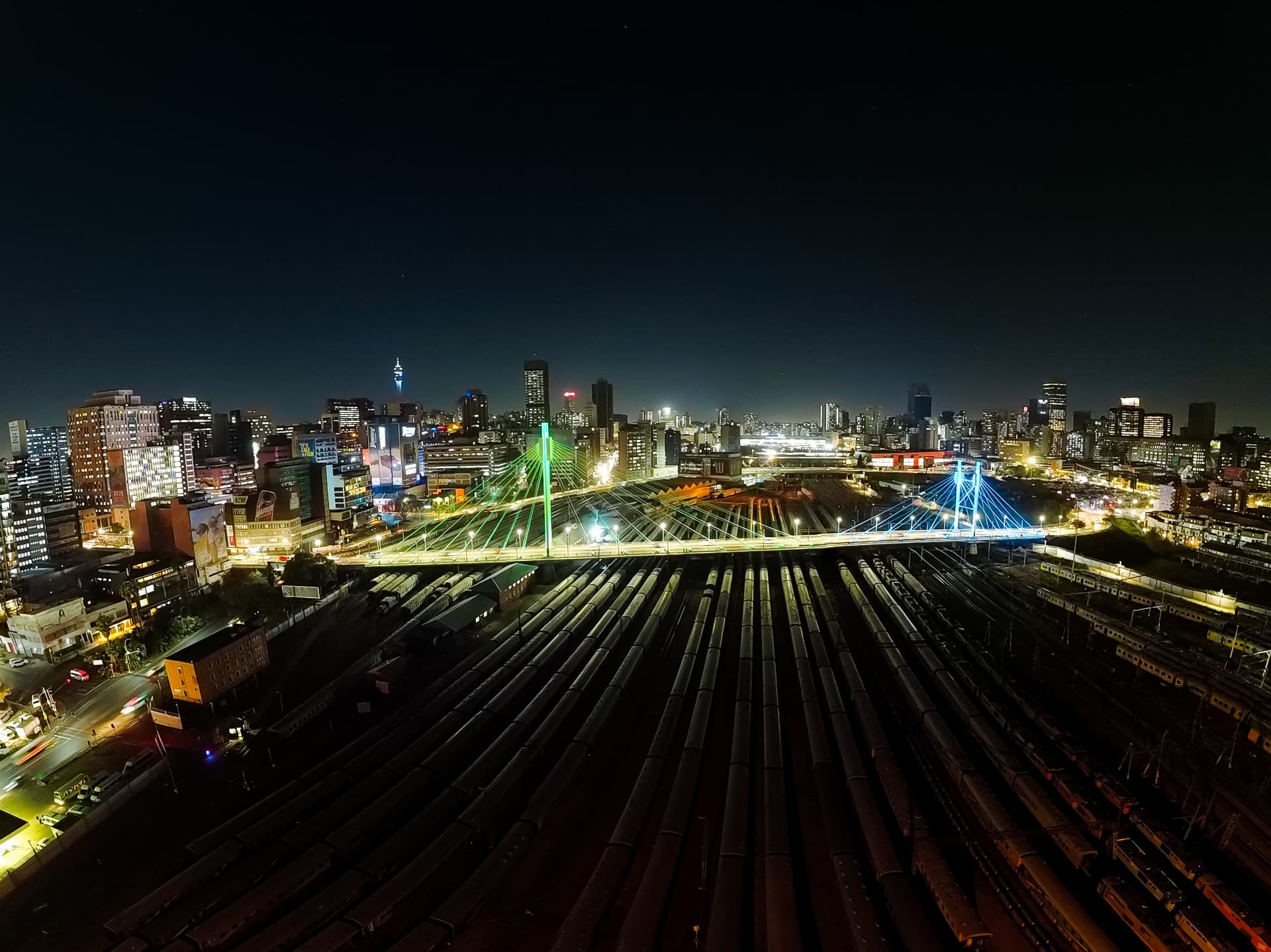 Night panorama of the Johannesburg skyline and Nelson Mandela Bridge over the rail yard
