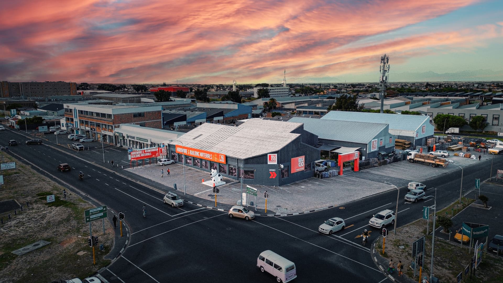 Aerial view of BUCO Tokai at sunset with pink and orange skies