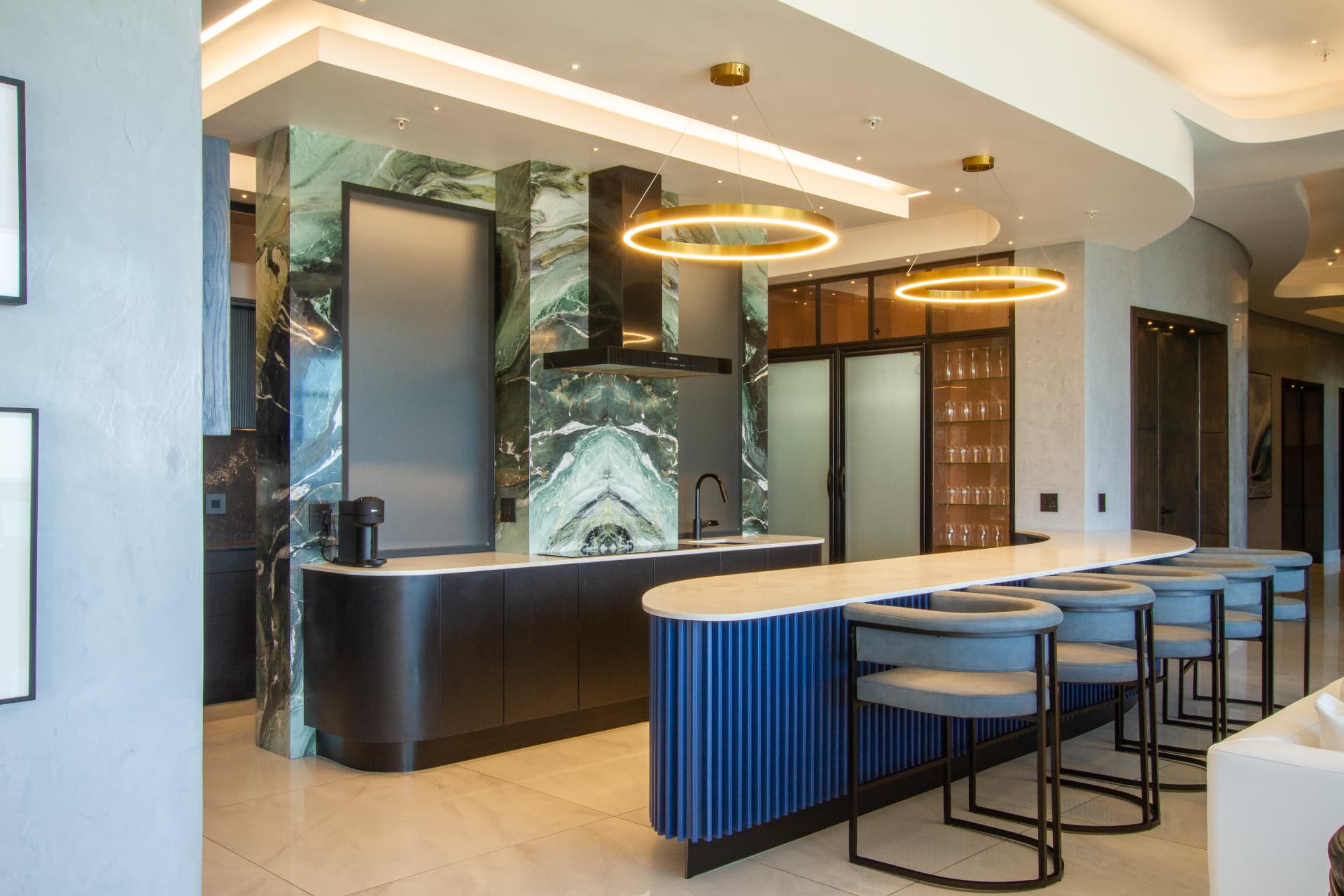 Ocean1 penthouse kitchen with marble feature wall and breakfast bar