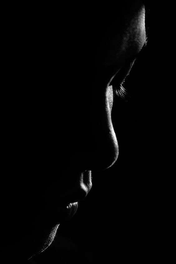 Low key black and white profile portrait with rim lighting