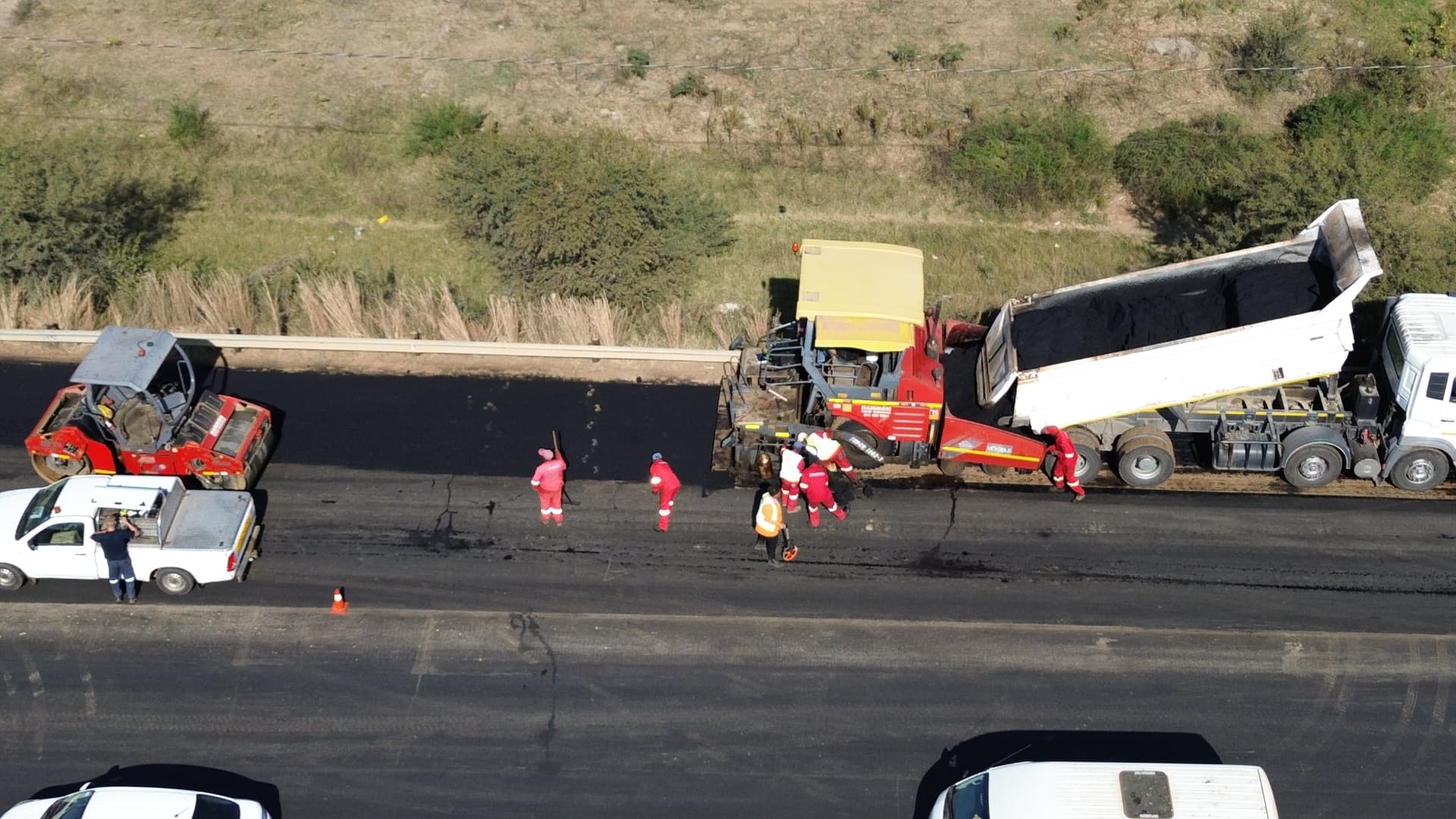Aerial view of road resurfacing crew and trucks in Free State, South Africa